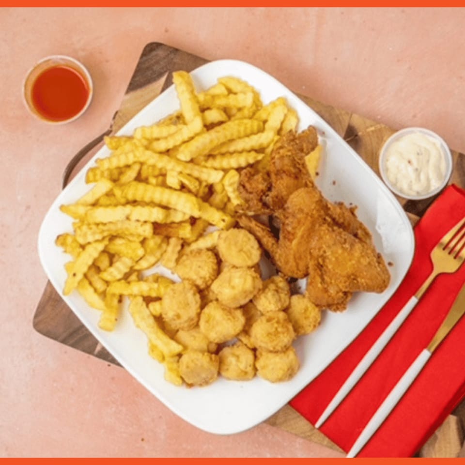 Snappers Fish and Chicken platter with fried chicken wings, popcorn shrimp, and crinkle-cut fries.