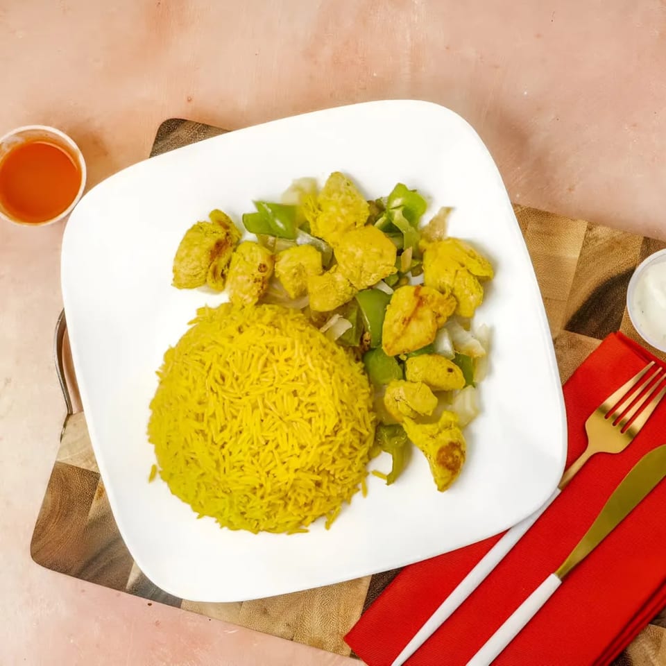 Snappers Fish and Chicken meal with yellow rice, chicken pieces, green peppers, and onions.